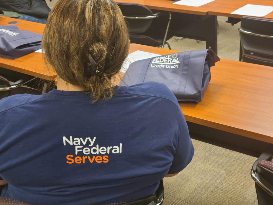 NFCU volunteer listens to attendees